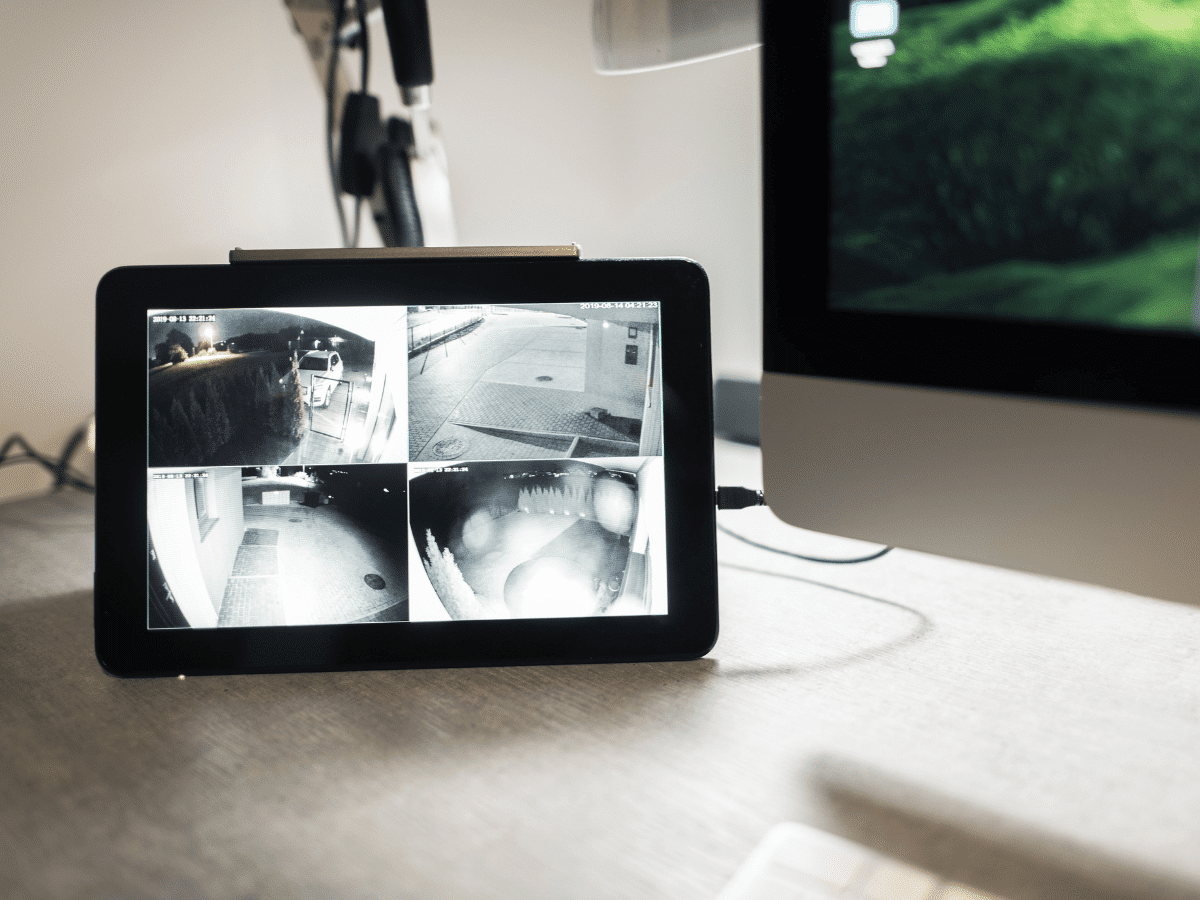 Tablet displaying four different security camera screens.