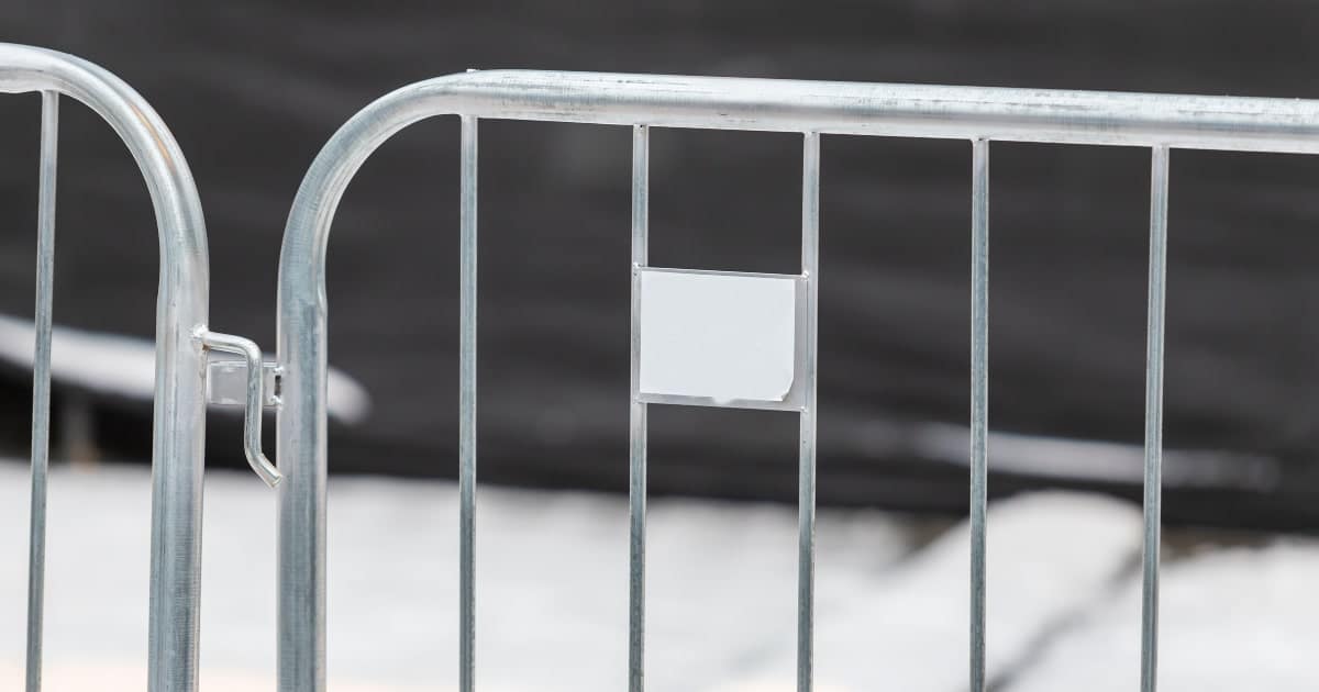 Close up of steel crowd control barriers.