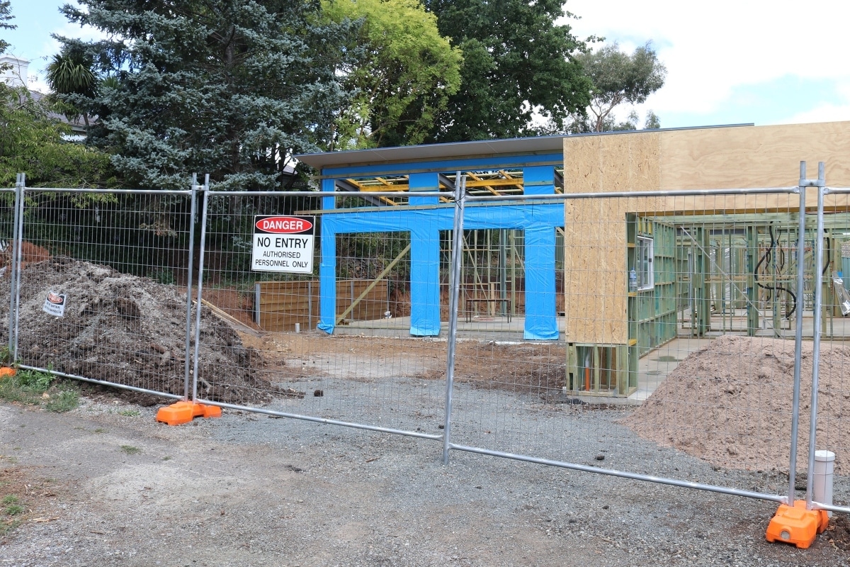 Home build construction site secured by temporary fencing.