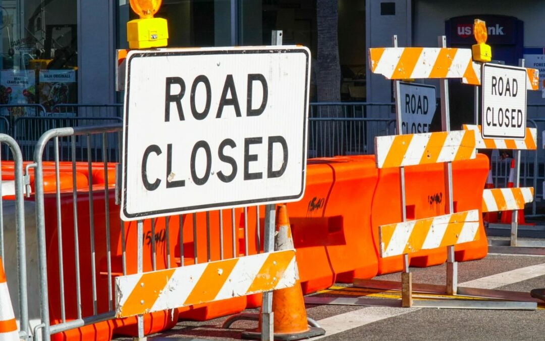 Barricading on a road to prevent traffic access, barriers and road closed signs.