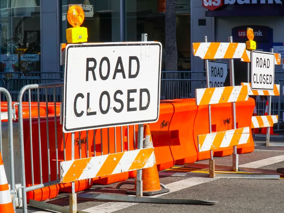 Barricading on a road to prevent traffic access, barriers and road closed signs.