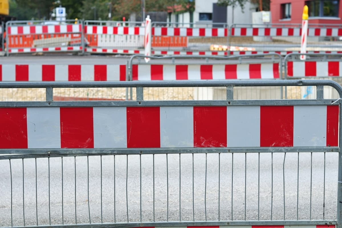 Rows of temporary barriers set up outside to direct traffice and pedestians.