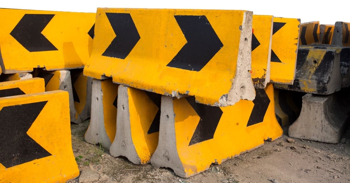 Yellow and black concrete barriers used from barricading roads.