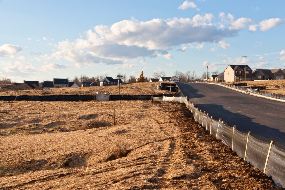 Silt fence installation at a building site.