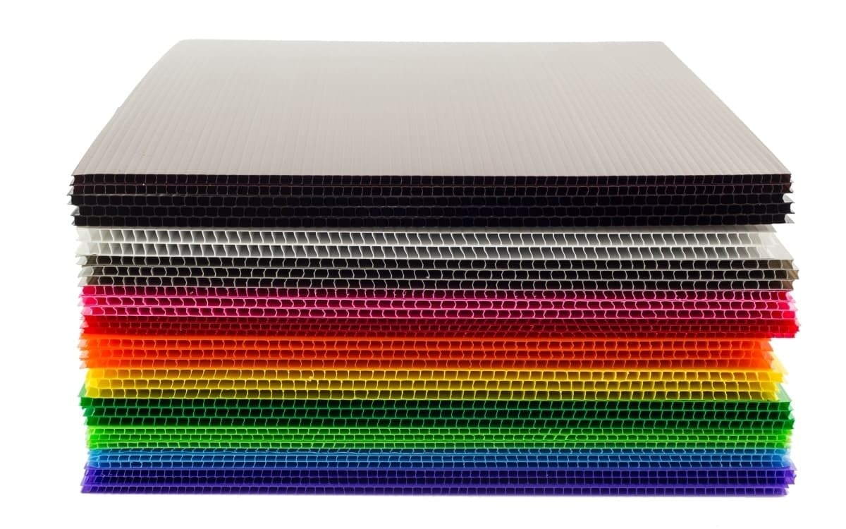What is corflute? A stack of brightly coloured corrugated plastic sheets.