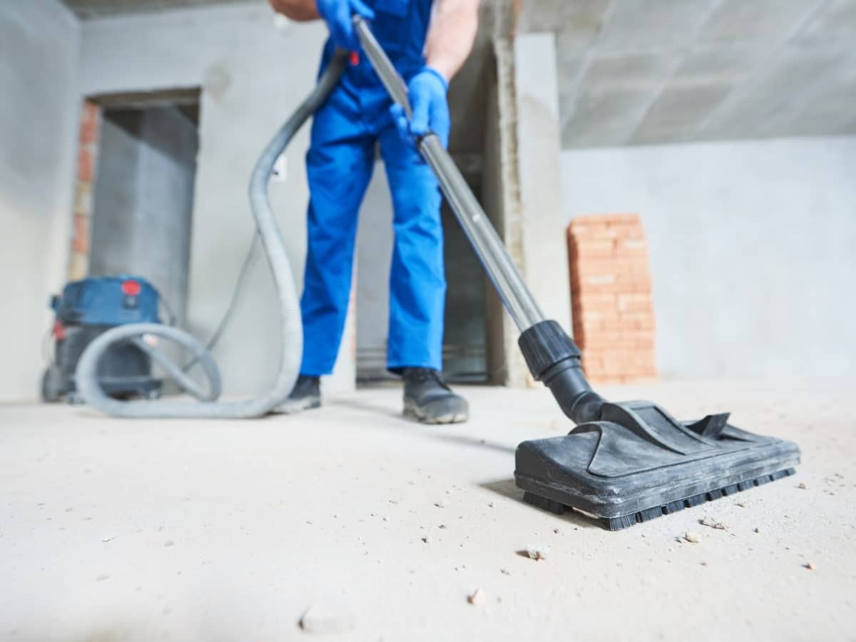 Industrial vacuum being used to clean a building site.