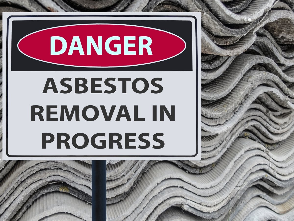 A warning sign that reads "Danger Asbestos Removal in Progress" with asbestos materials in the background.