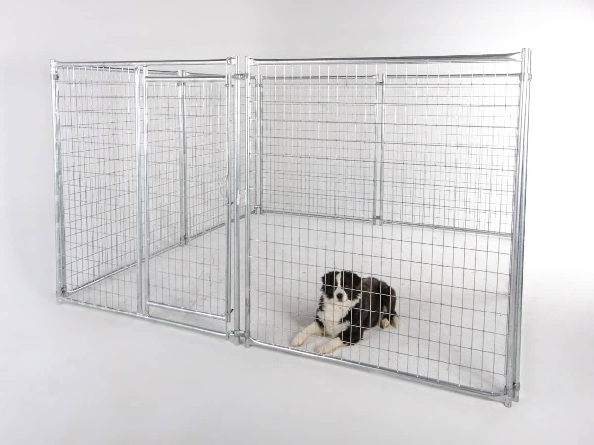 The image showcases a versatile temporary fencing solution for dogs, with a dog resting inside a metal pet enclosure, highlighting a practical and portable option for pet owners.