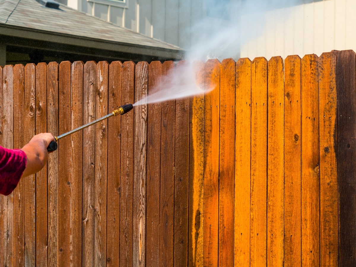 Pressure cleaning wooden fence.