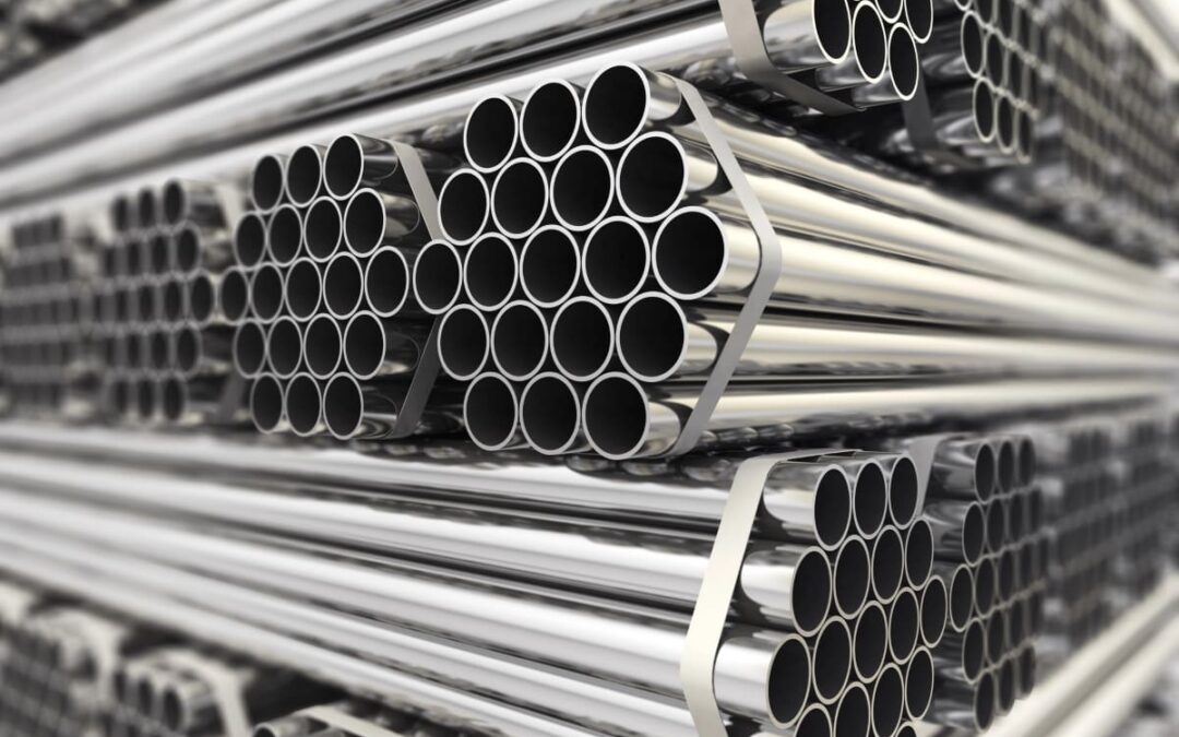 Stacks of steel pipes with a reflective zinc finish, a visual answer to the question What is galvanising?