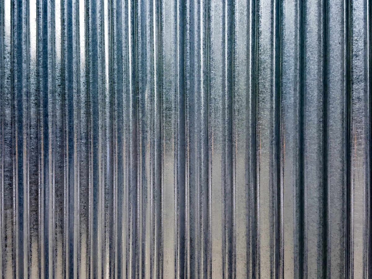 Close up image of corrugated steel with zinc coating.