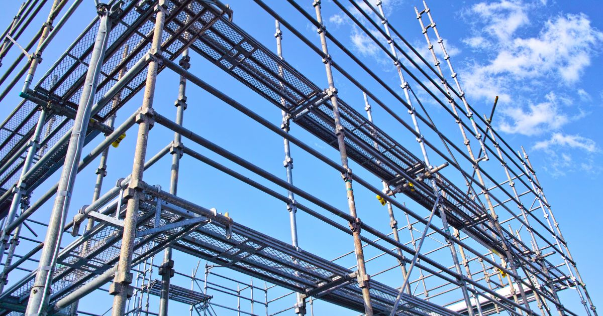 Scaffold setup, showcasing scaffolding parts, against a blue sky.