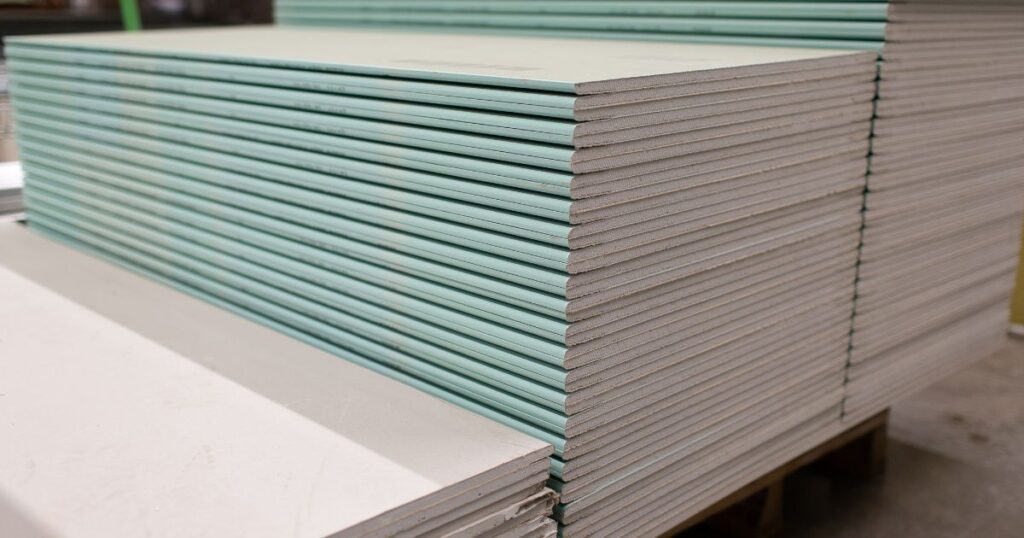 Top 10 Scaffolding Parts All Builders Should Know for Safe Construction 6 A stack of toe boards that are used for edge protection on scaffolding.