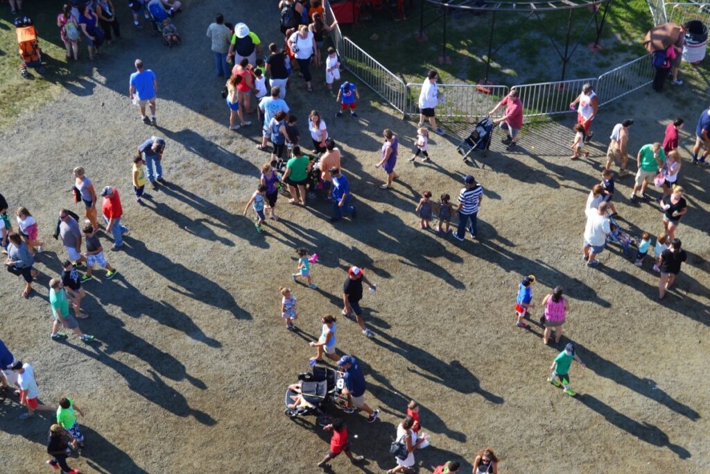 Aerial view of a crowd at a sports event, with barriers set up to manage crowd flow.